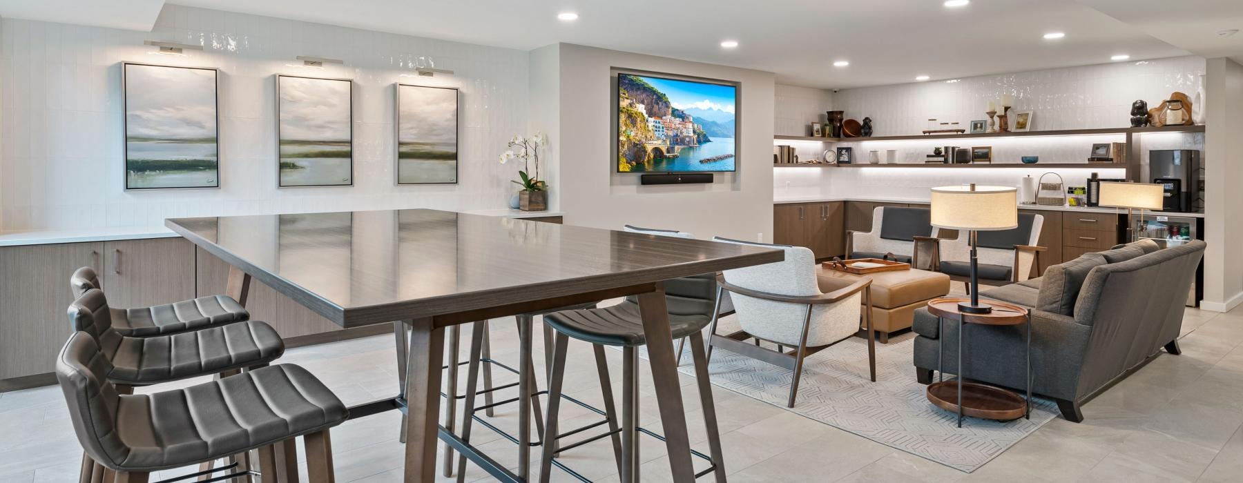 a room with a table chairs and a tv