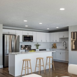 a kitchen with an island and seating