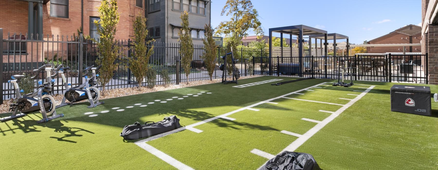 a group of bicycles parked on a grass field in front of a building