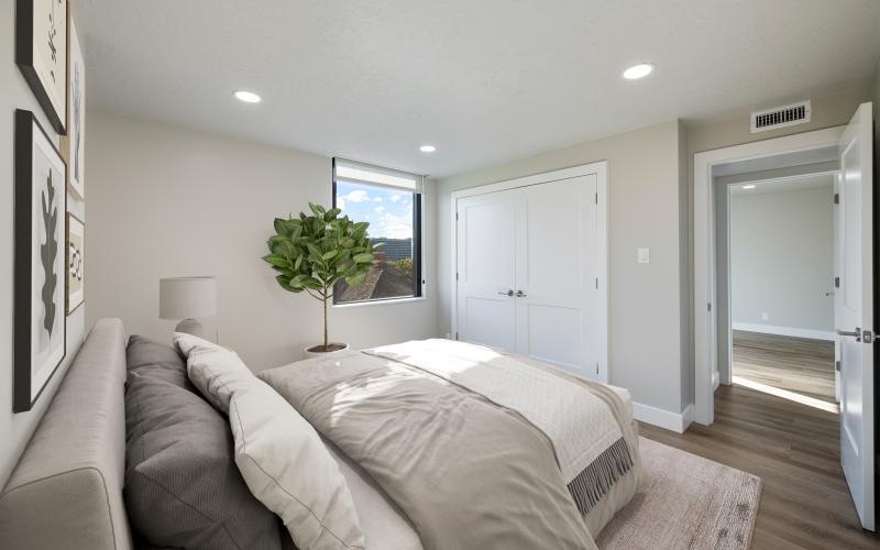 a bedroom with a bed and a plant