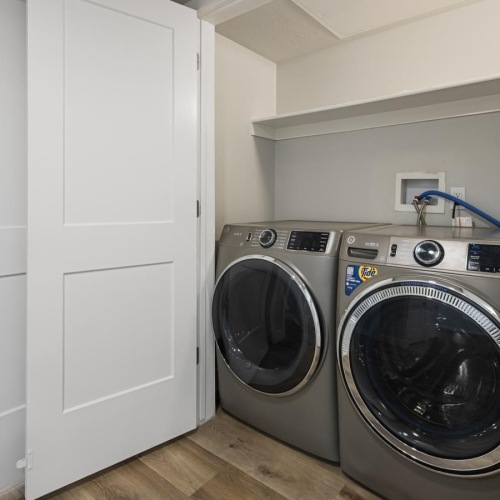 a washing machine and dryer in a room